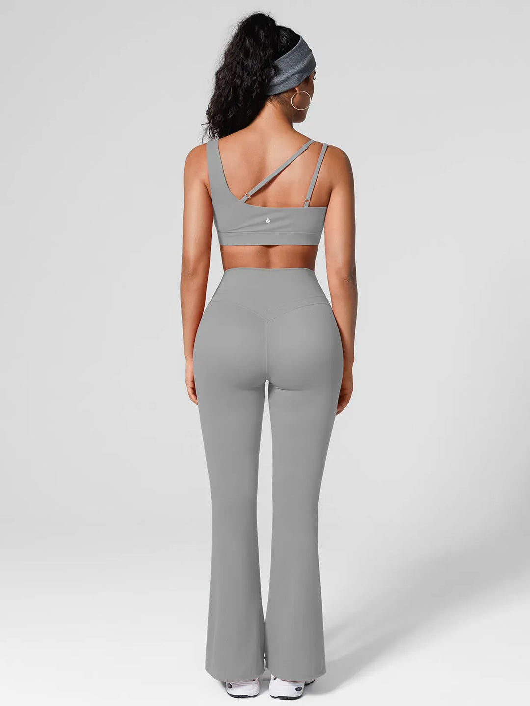 A model wearing a BRXL® High Rise Flared Side Pockets Scrunch Leggings in