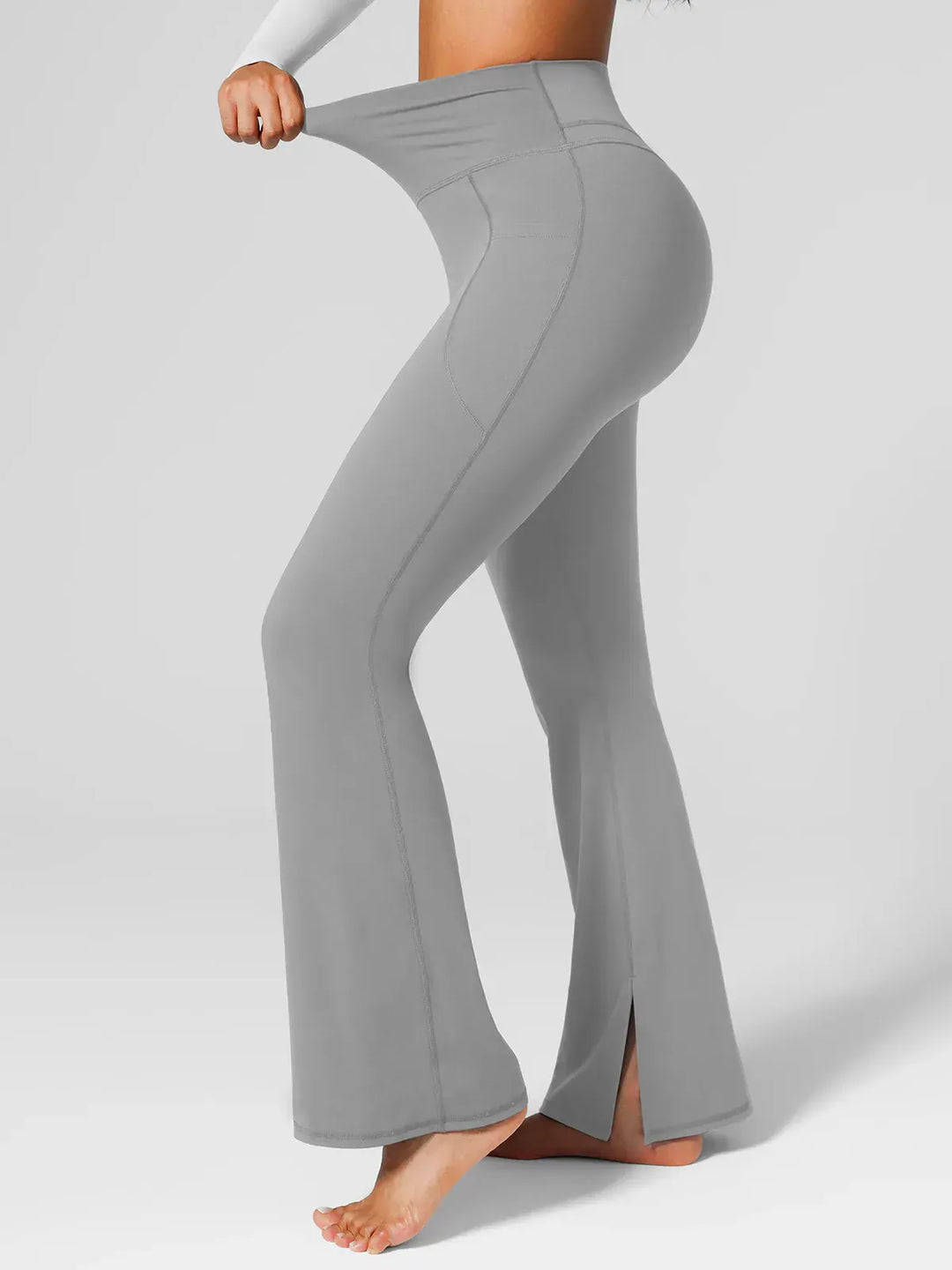 A model wearing a BRXL® High Rise Flared Side Pockets Scrunch Leggings in