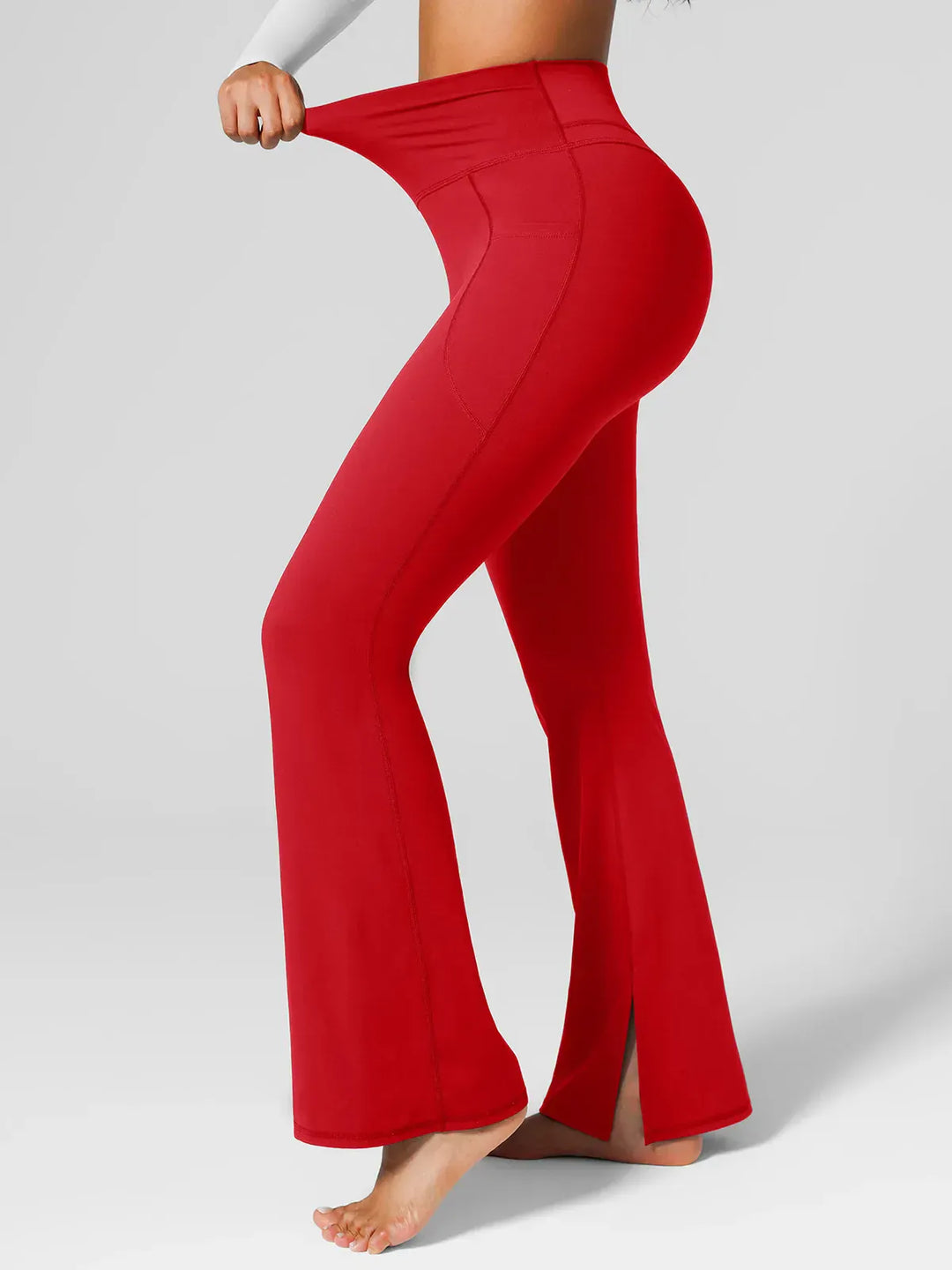 A model wearing a BRXL® High Rise Flared Side Pockets Scrunch Leggings in