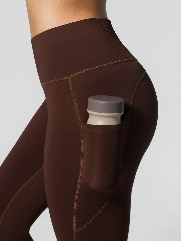 A model wearing a BRXL® High Rise Side Pockets Fleece Lined Leggings in