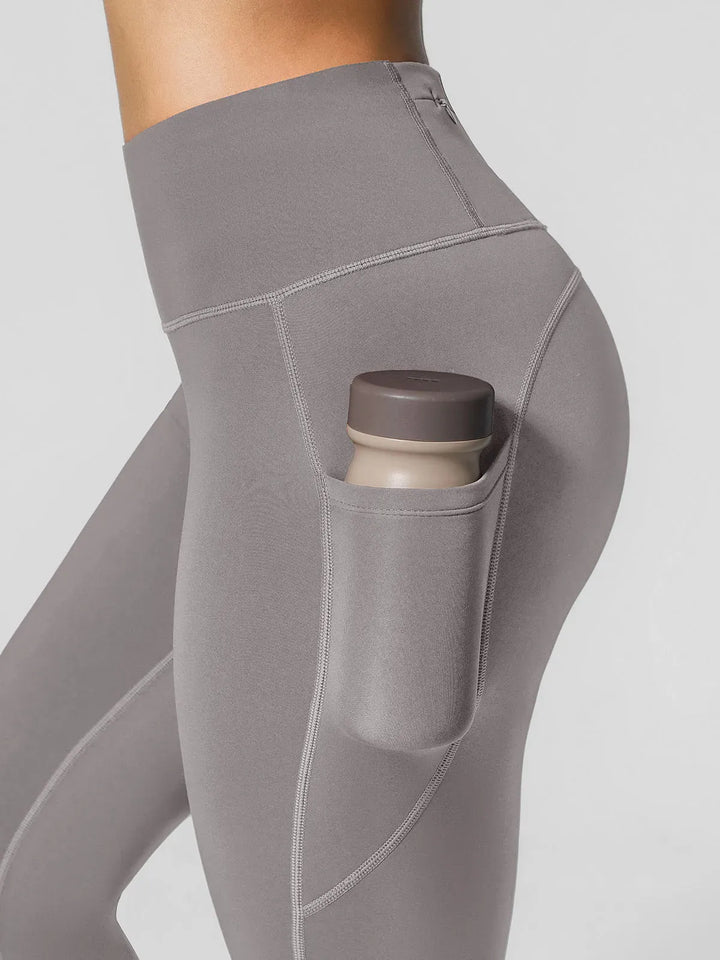 A model wearing a BRXL® High Rise Side Pockets Fleece Lined Leggings in