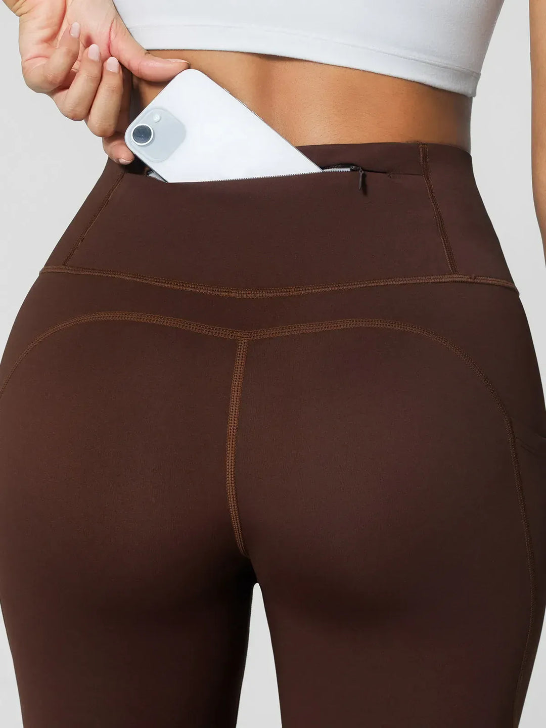 A model wearing a BRXL® High Rise Side Pockets Fleece Lined Leggings in