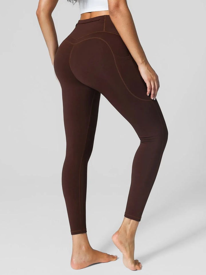 A model wearing a BRXL® High Rise Side Pockets Fleece Lined Leggings in