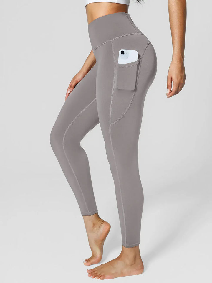A model wearing a BRXL® High Rise Side Pockets Fleece Lined Leggings in Gray / XS