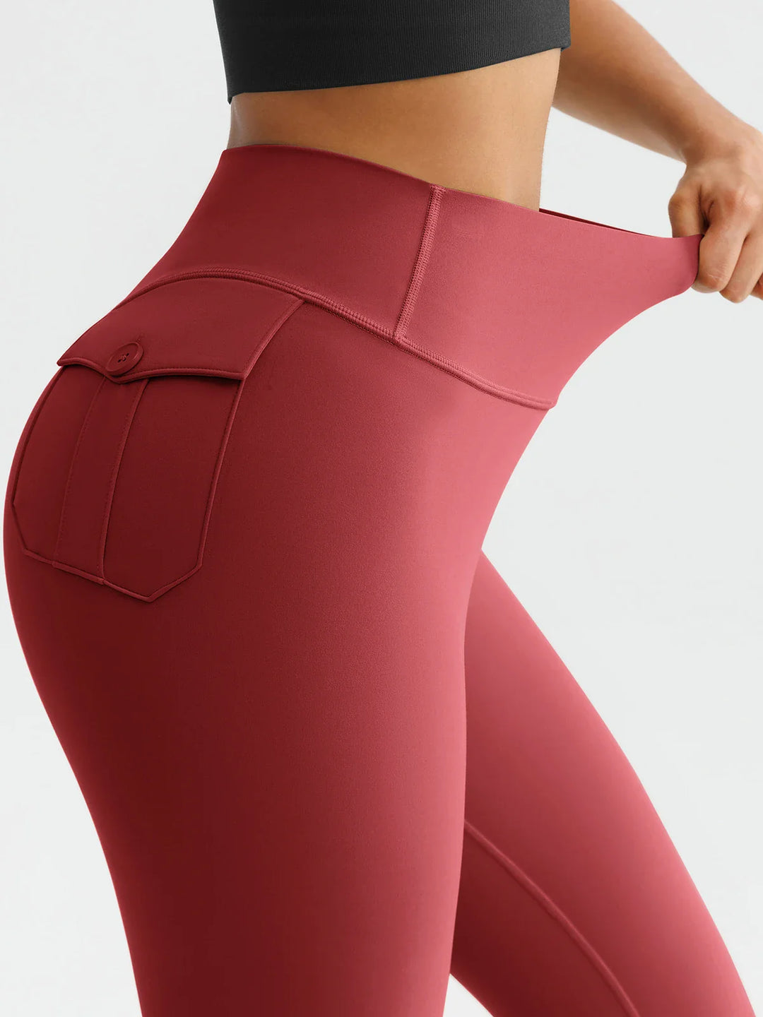 A model wearing a BRXL® High-Waisted Hidden Scrunch Leggings with Cargo Pockets