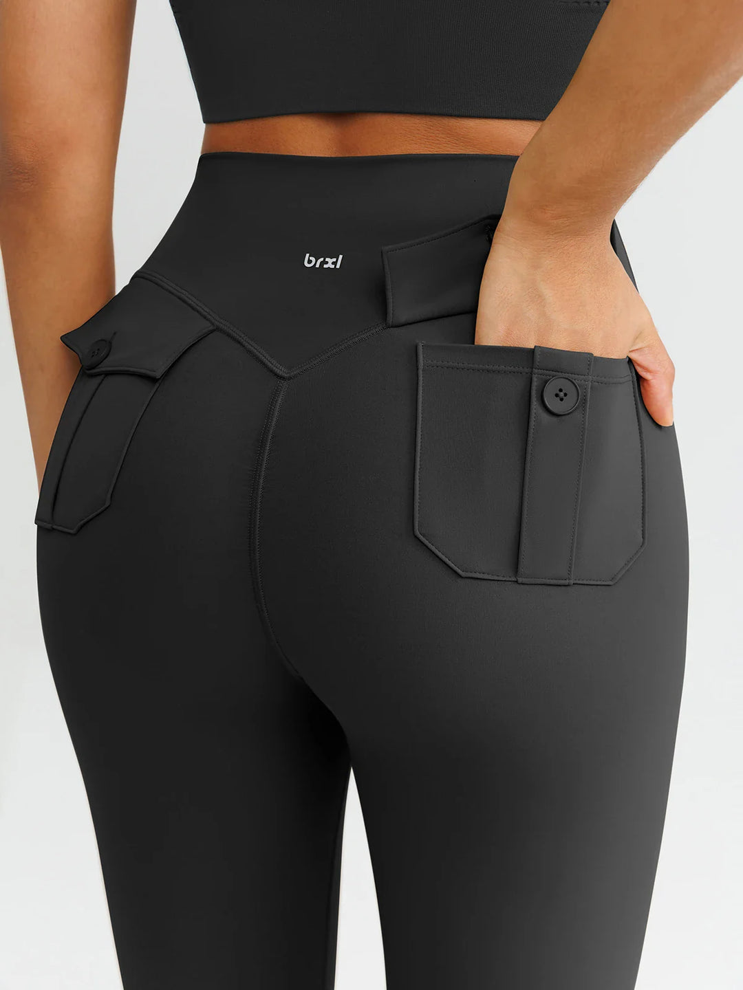 A model wearing a BRXL® High-Waisted Hidden Scrunch Leggings with Cargo Pockets