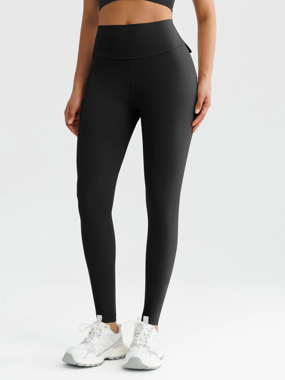 A model wearing a BRXL® High-Waisted Hidden Scrunch Leggings with Cargo Pockets