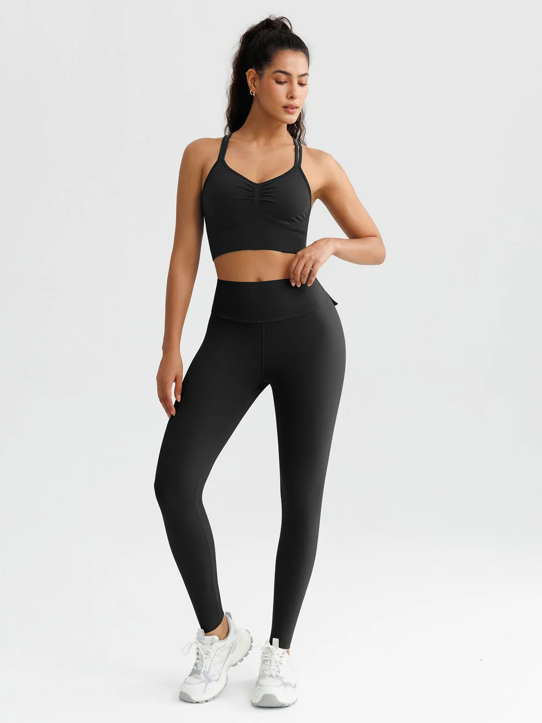 A model wearing a BRXL® High-Waisted Hidden Scrunch Leggings with Cargo Pockets