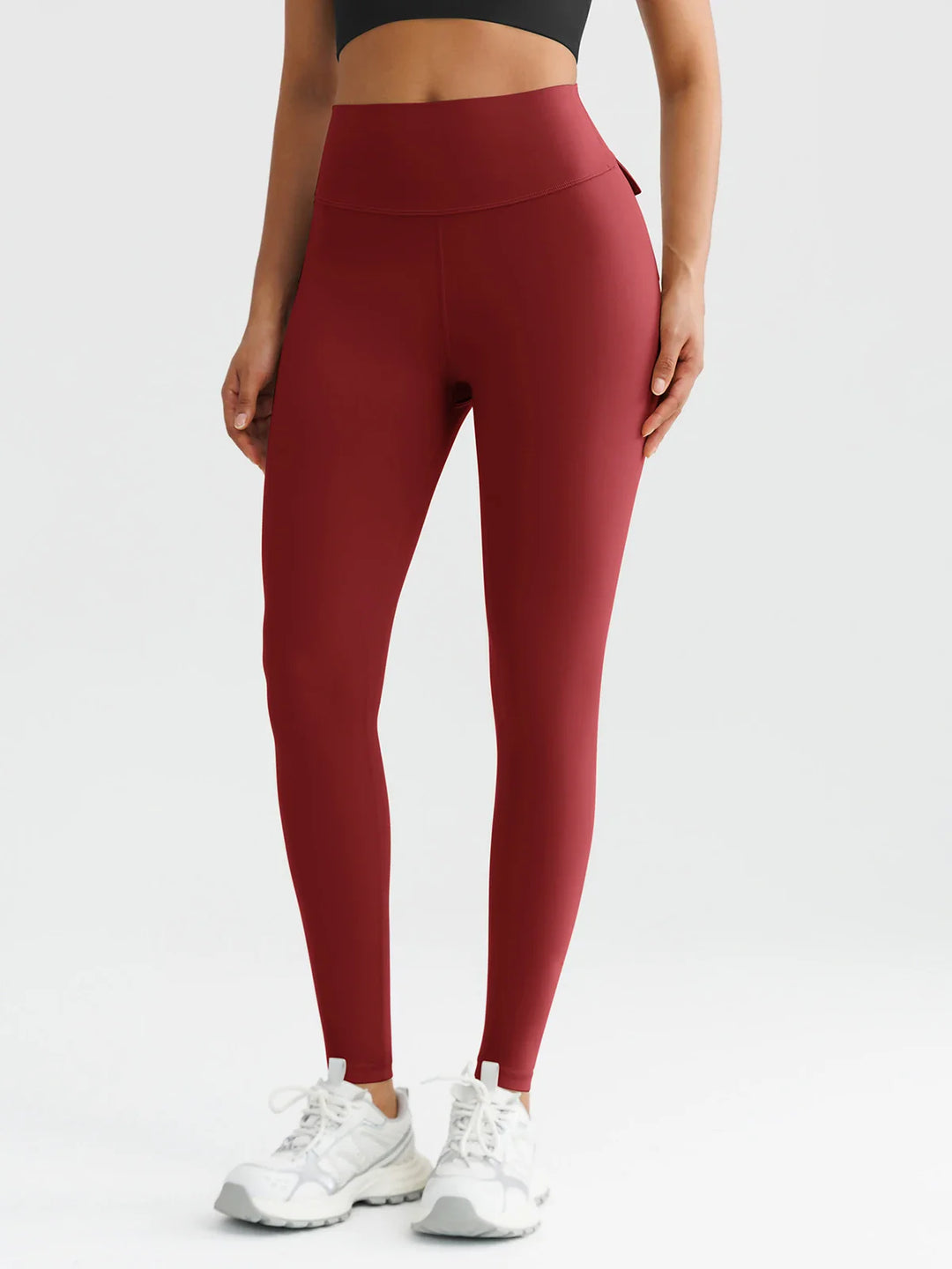 A model wearing a BRXL® High-Waisted Hidden Scrunch Leggings with Cargo Pockets