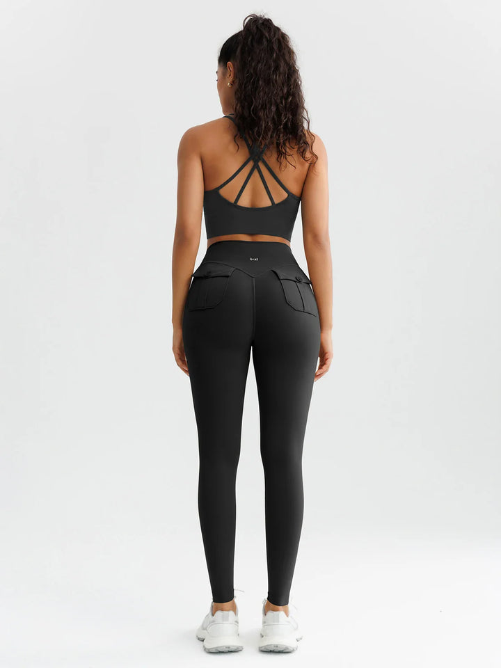 A model wearing a BRXL® High-Waisted Hidden Scrunch Leggings with Cargo Pockets