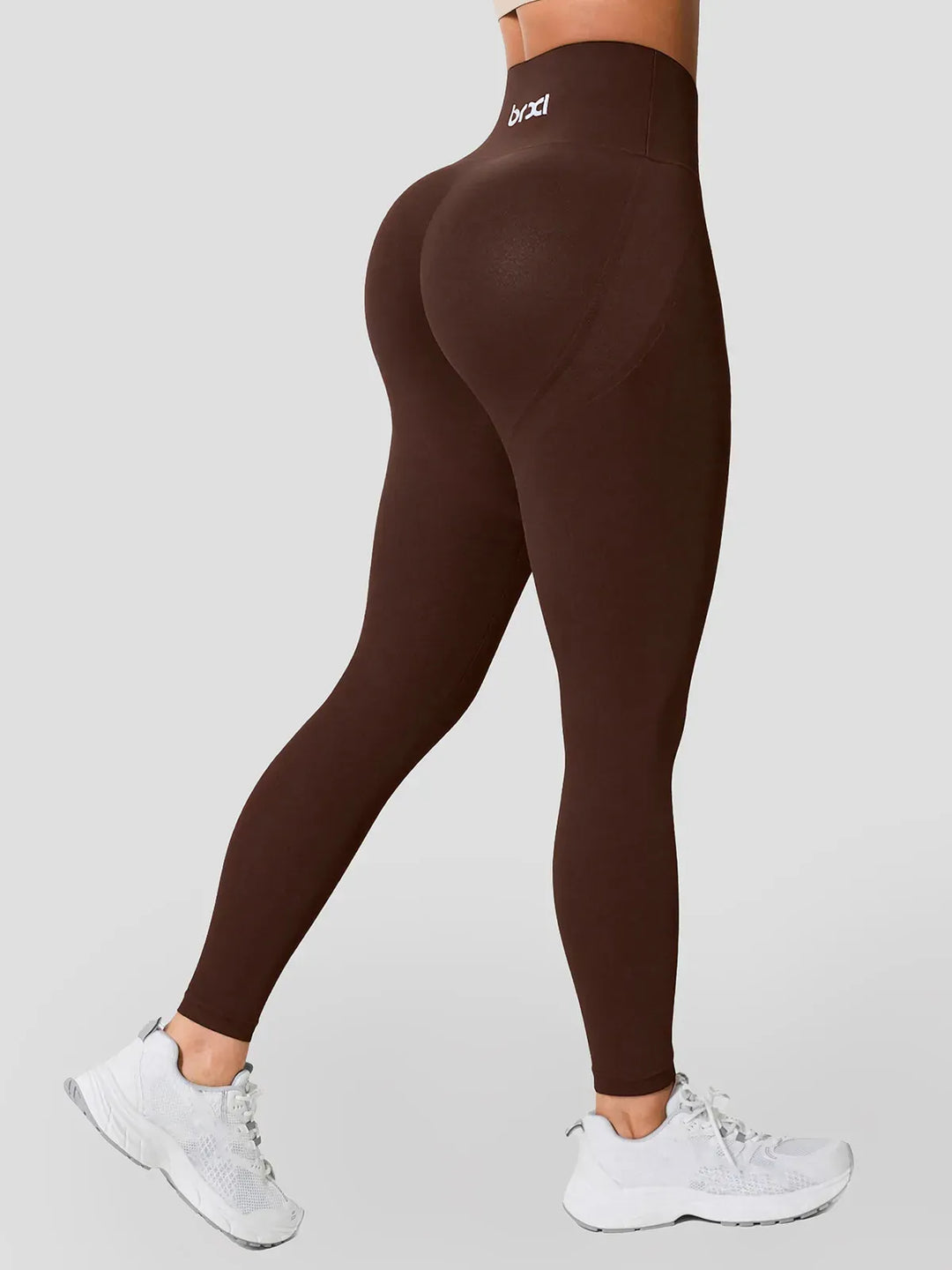 A model wearing a BRXL® High Waisted Seamless Butt-Lifting Leggings With Tummy Control in Brown / XS