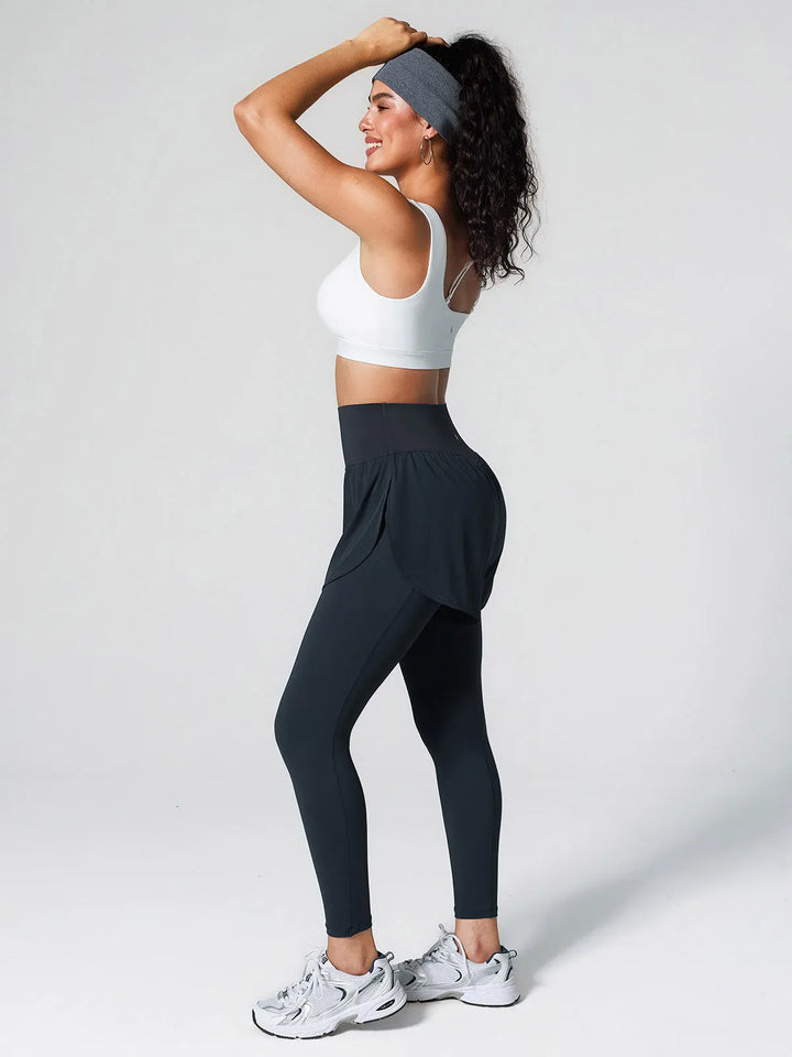 A model wearing a BRXL® Layered Combo Short Leggings in