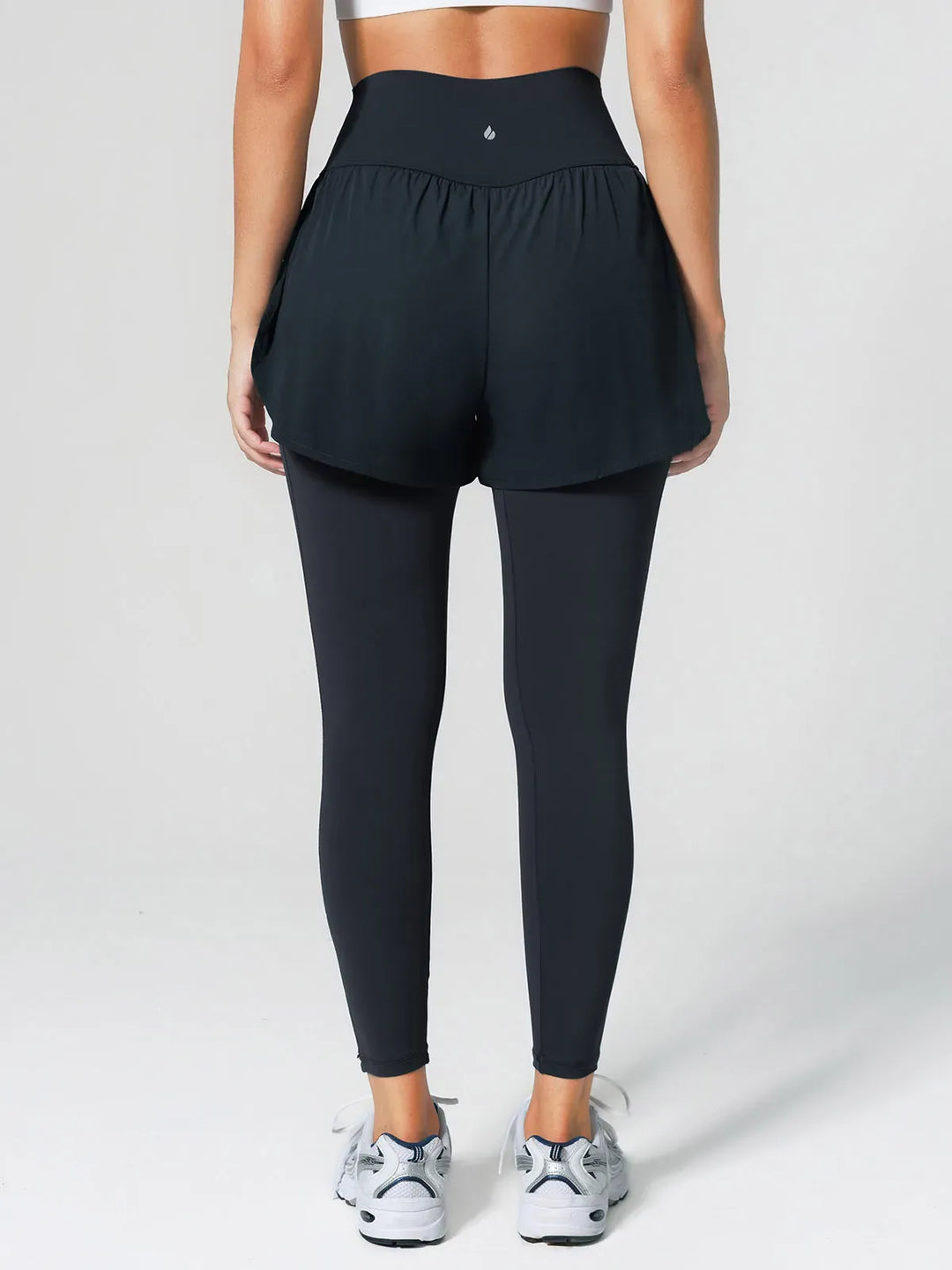 A model wearing a BRXL® Layered Combo Short Leggings in
