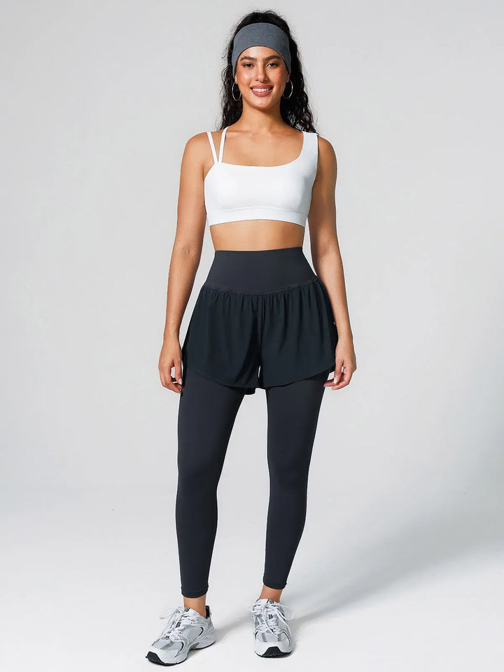 A model wearing a BRXL® Layered Combo Short Leggings in