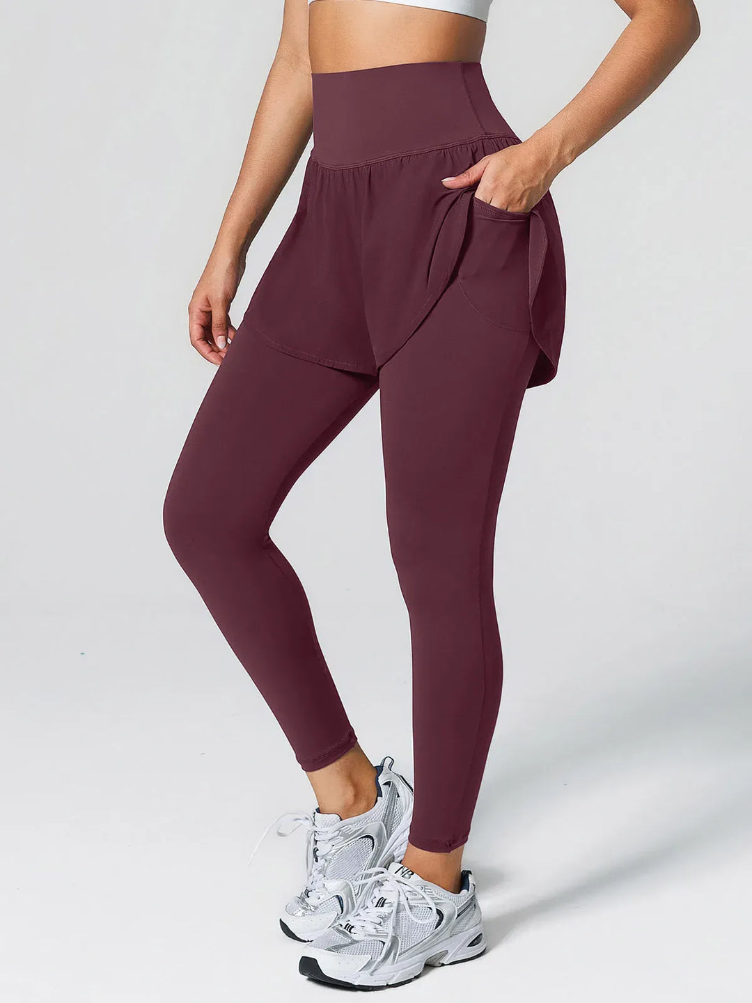 A model wearing a BRXL® Layered Combo Short Leggings in