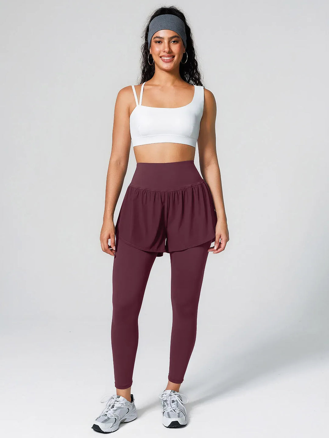 A model wearing a BRXL® Layered Combo Short Leggings in