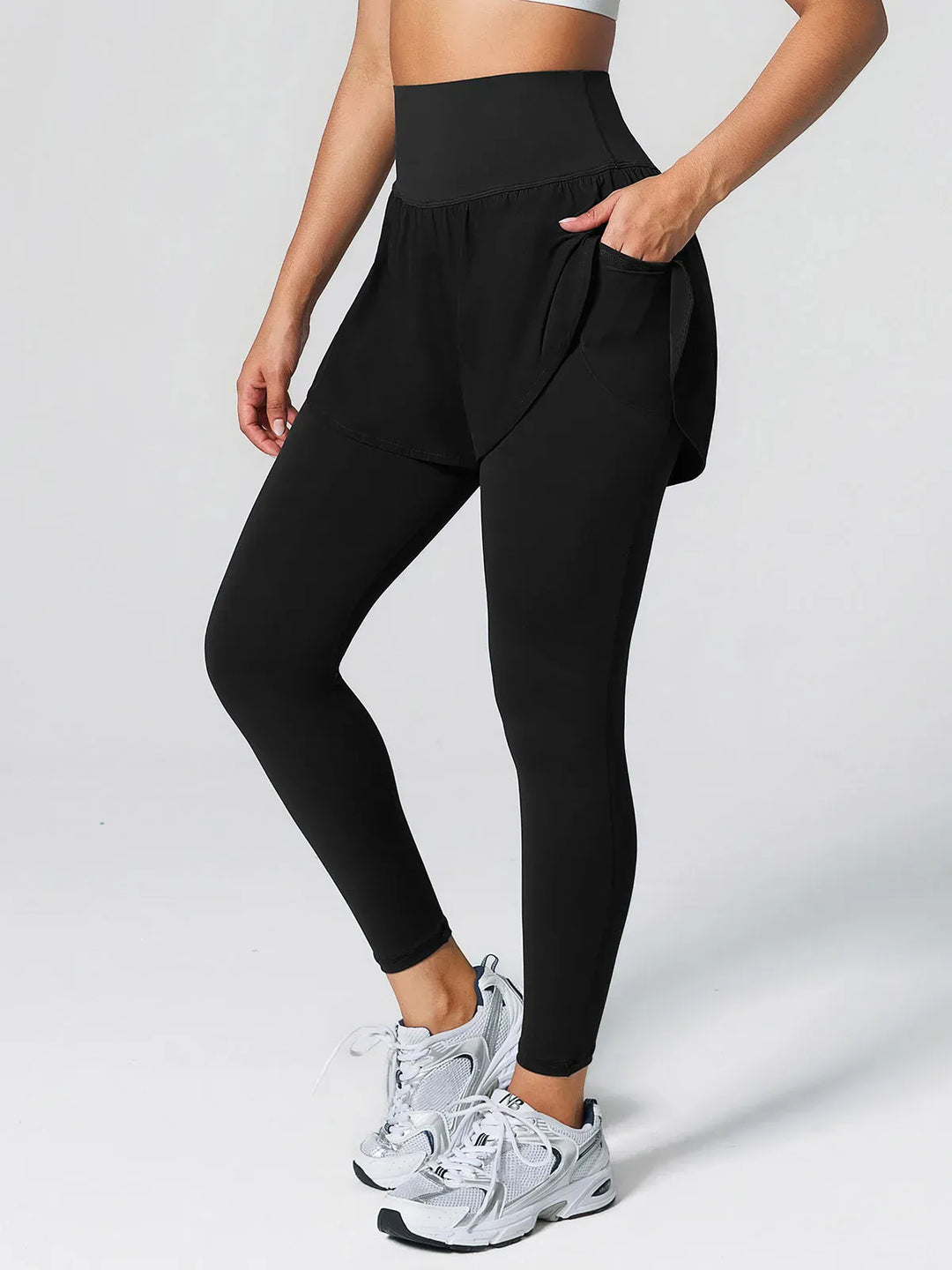 A model wearing a BRXL® Layered Combo Short Leggings in