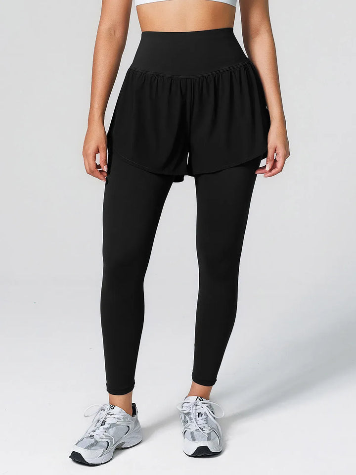 A model wearing a BRXL® Layered Combo Short Leggings in Black / XS