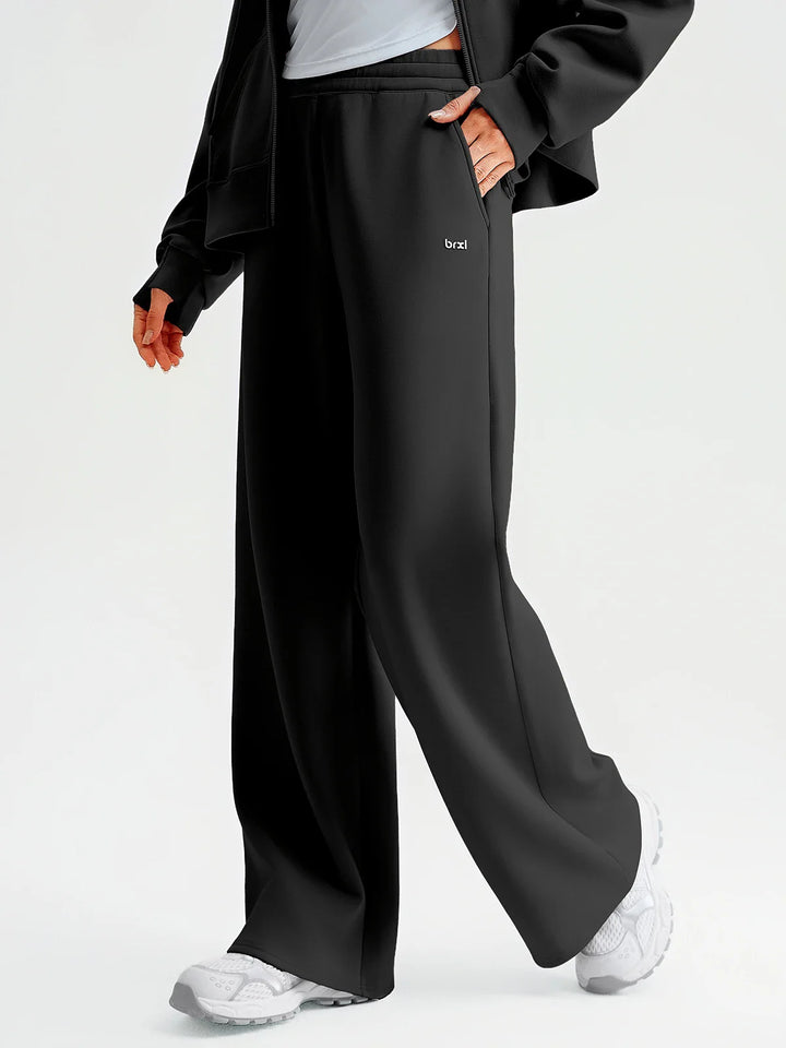 A model wearing a BRXL® Lightweight Mid-Rise Wide Leg Baggy Sweatpants
