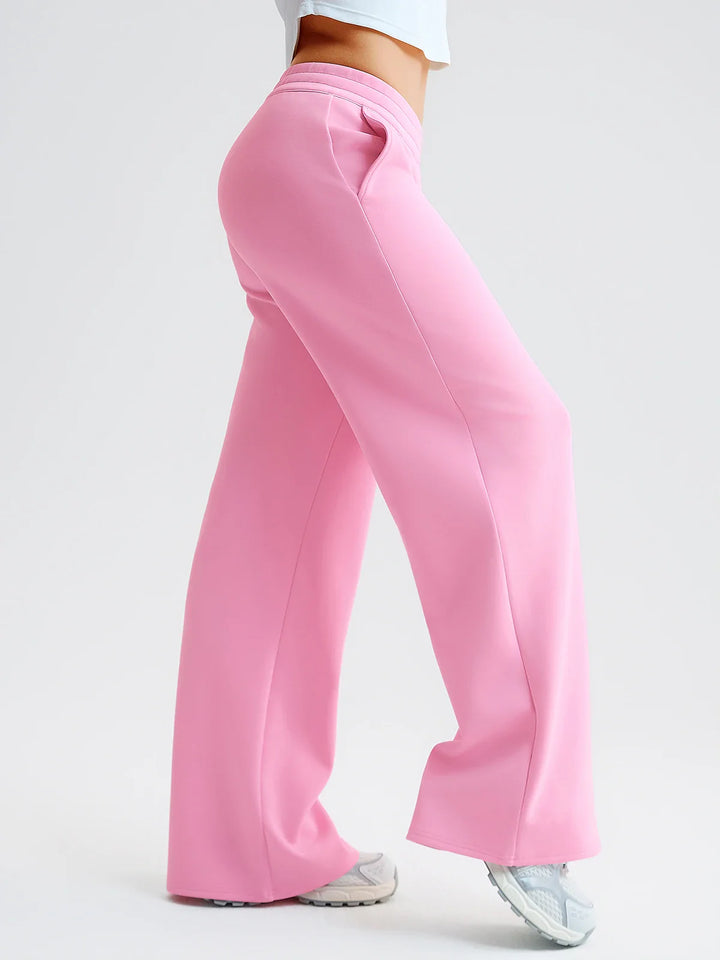 A model wearing a BRXL® Lightweight Mid-Rise Wide Leg Baggy Sweatpants
