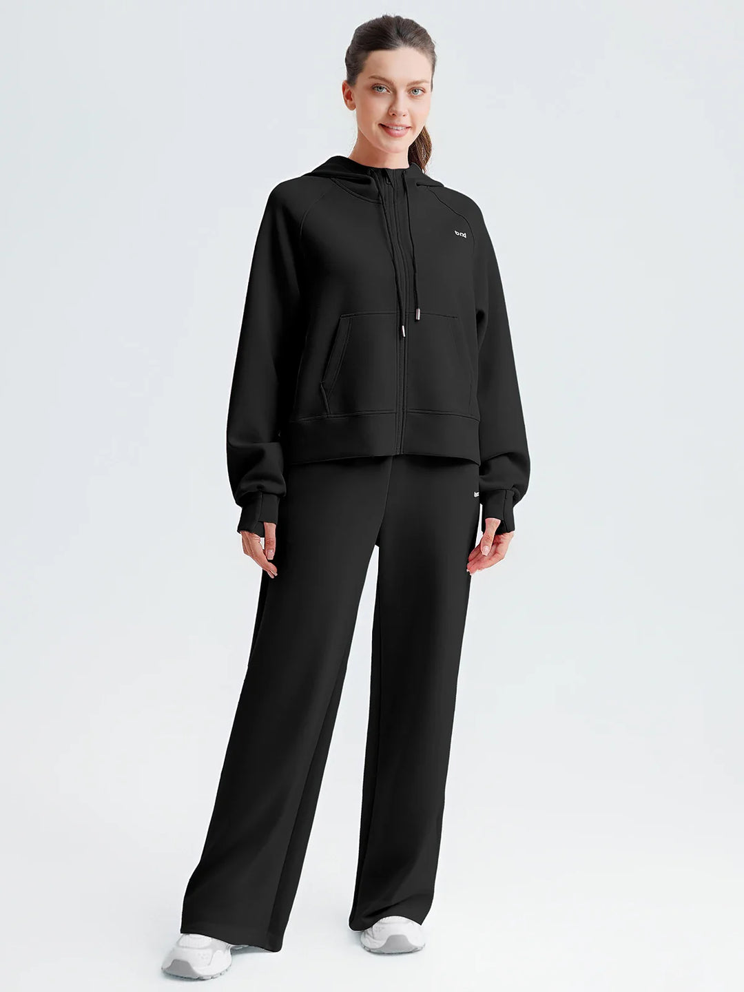 A model wearing a BRXL® Lightweight Mid-Rise Wide Leg Baggy Sweatpants