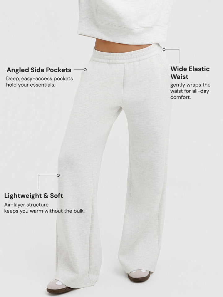 A model wearing a BRXL® Lightweight Mid-Rise Wide Leg Baggy Sweatpants