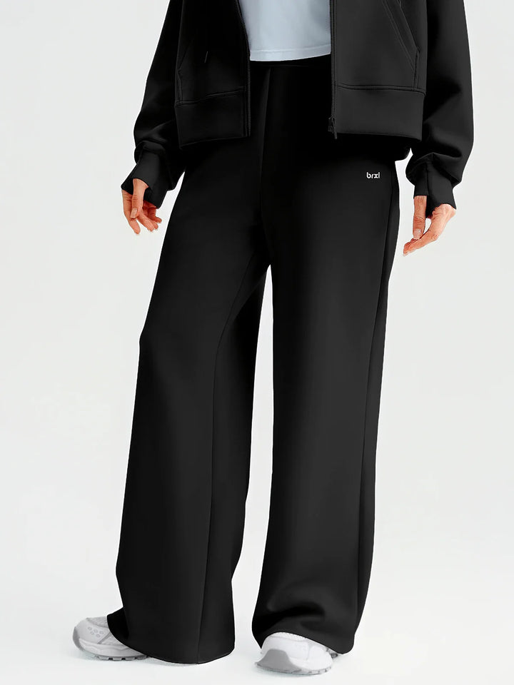 A model wearing a BRXL® Lightweight Mid-Rise Wide Leg Baggy Sweatpants Black / XS
