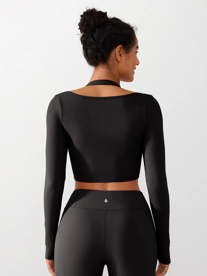 A model wearing a BRXL® Long Sleeve Halter Shrug Top with Buckle and Thumbhole in