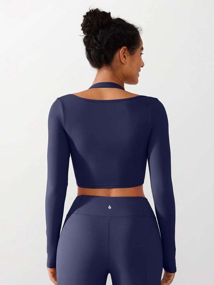 A model wearing a BRXL® Long Sleeve Halter Shrug Top with Buckle and Thumbhole in