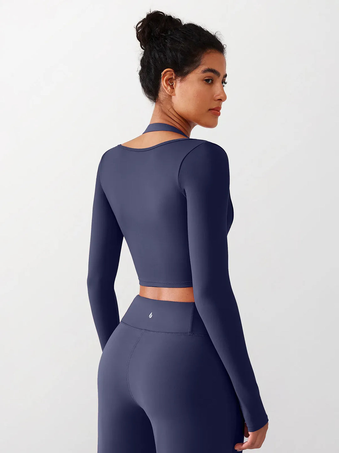 A model wearing a BRXL® Long Sleeve Halter Shrug Top with Buckle and Thumbhole in