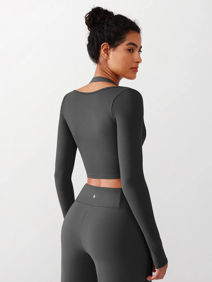 A model wearing a BRXL® Long Sleeve Halter Shrug Top with Buckle and Thumbhole in