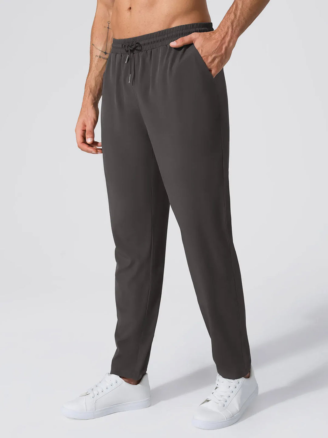 A model wearing a BRXL® Men’s  Adjustable Waist Tapered Activewear Joggers in Dark Gray / S