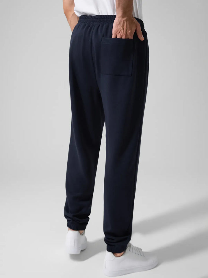 A model wearing a BRXL® Men's Four Pockets Drawstring Waist Activewear Sweatpants in