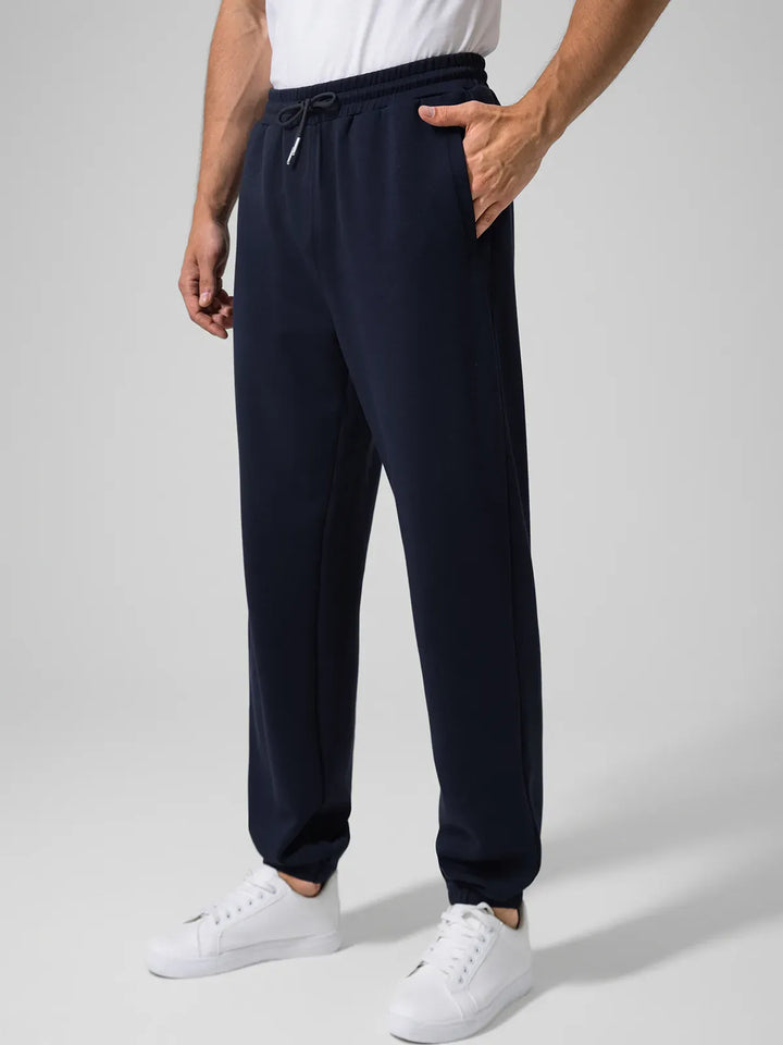 A model wearing a BRXL® Men's Four Pockets Drawstring Waist Activewear Sweatpants in