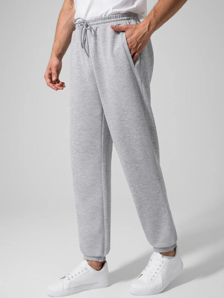 A model wearing a BRXL® Men's Four Pockets Drawstring Waist Activewear Sweatpants in
