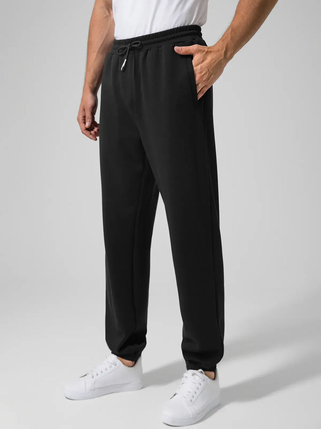 A model wearing a BRXL® Men's Four Pockets Drawstring Waist Activewear Sweatpants in