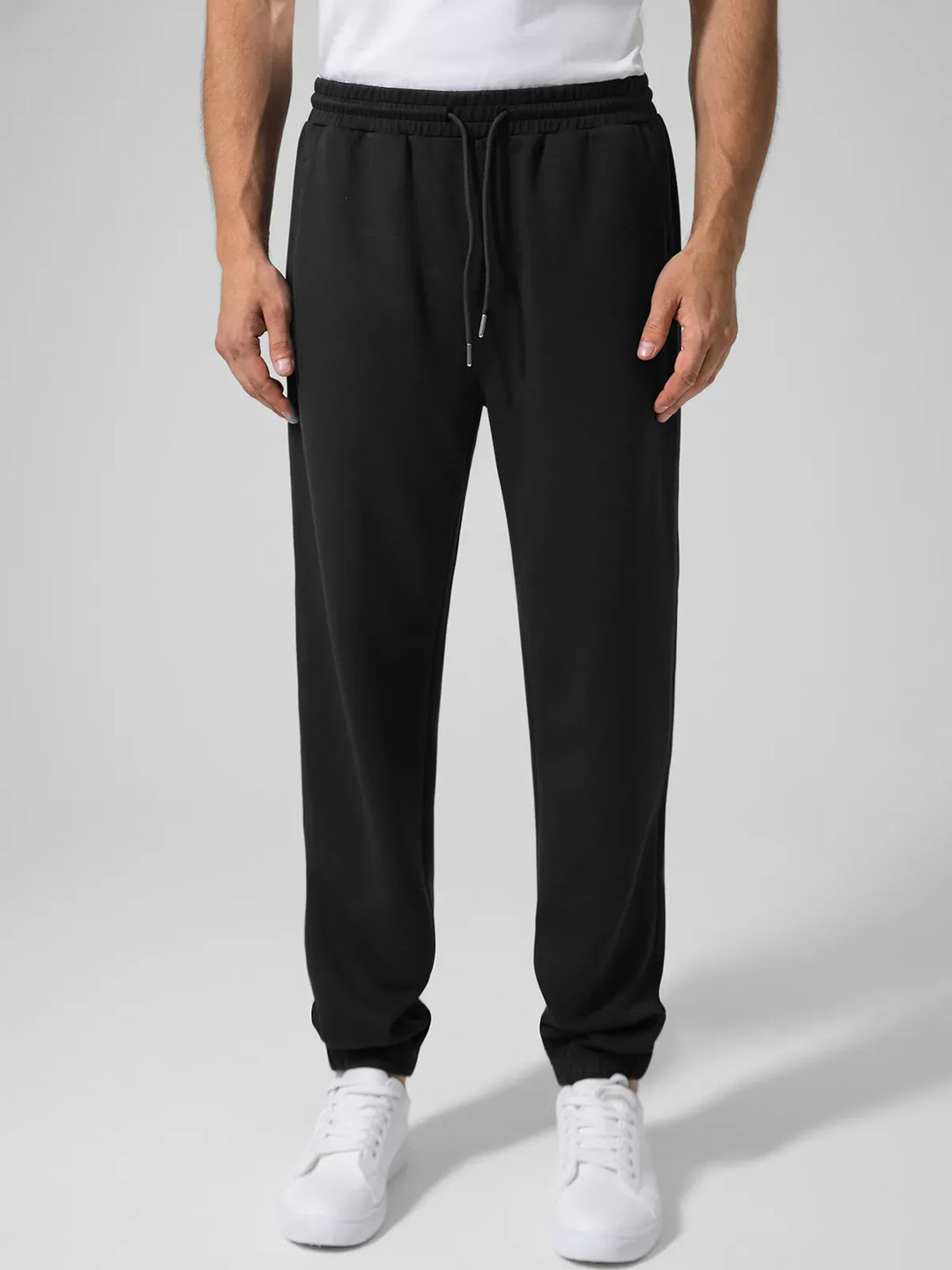 A model wearing a BRXL® Men's Four Pockets Drawstring Waist Activewear Sweatpants in Black / XS