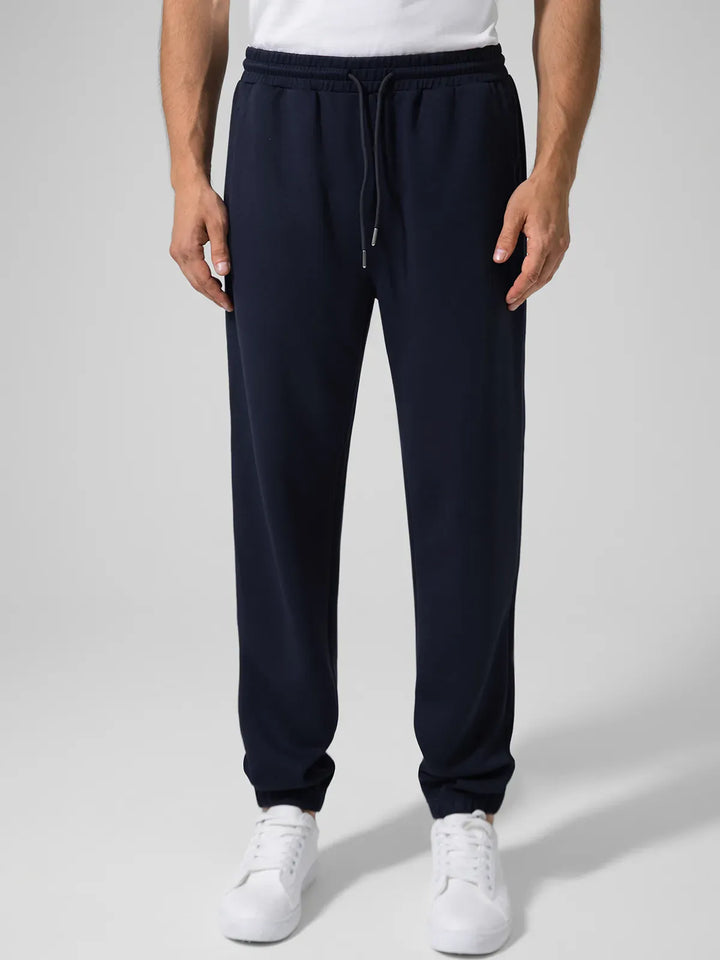 A model wearing a BRXL® Men's Four Pockets Drawstring Waist Activewear Sweatpants in Blue / XS