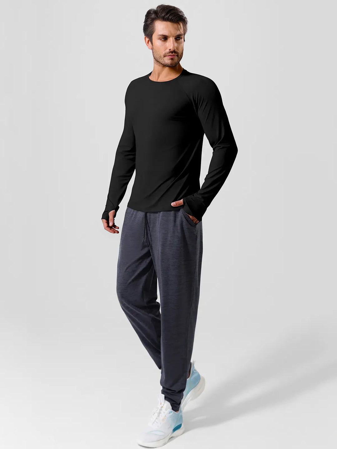 A model wearing a BRXL® Men’s Long Sleeve Thumbhole Activewear Shirt in