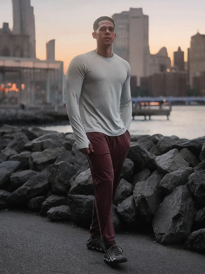 A model wearing a BRXL® Men’s Long Sleeve Thumbhole Activewear Shirt