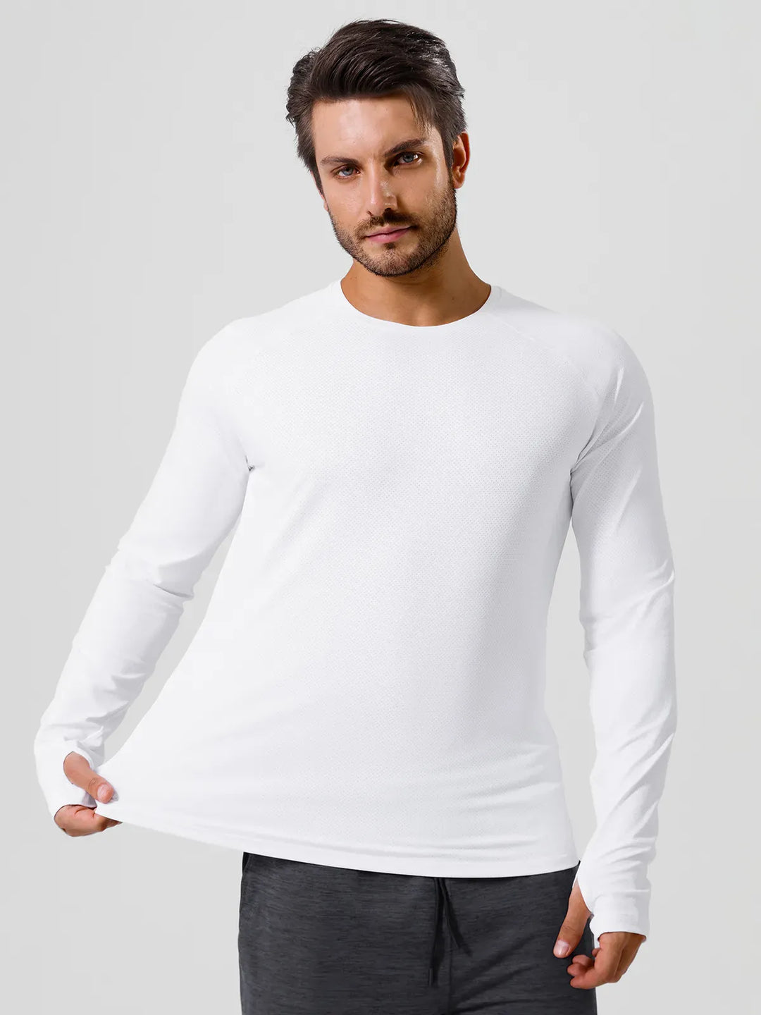 A model wearing a BRXL® Men’s Long Sleeve Thumbhole Activewear Shirt in White / XS
