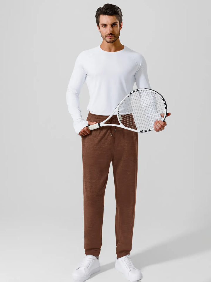 A model wearing a BRXL® Men’s Smooth Four Pockets Tapered Joggers in