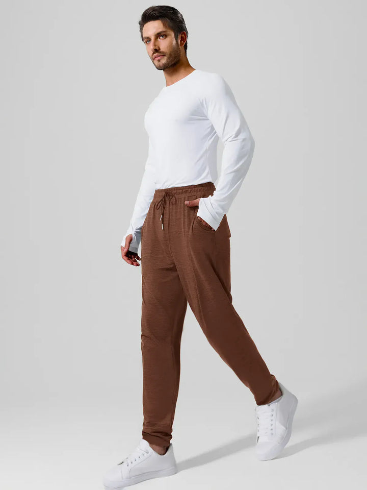 A model wearing a BRXL® Men’s Smooth Four Pockets Tapered Joggers in