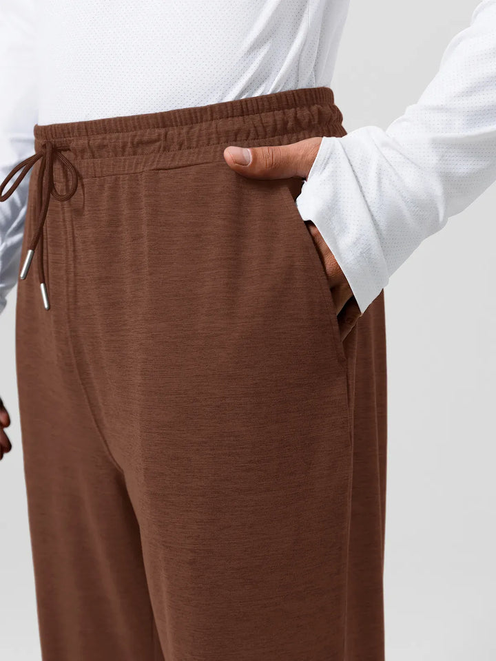 A model wearing a BRXL® Men’s Smooth Four Pockets Tapered Joggers in