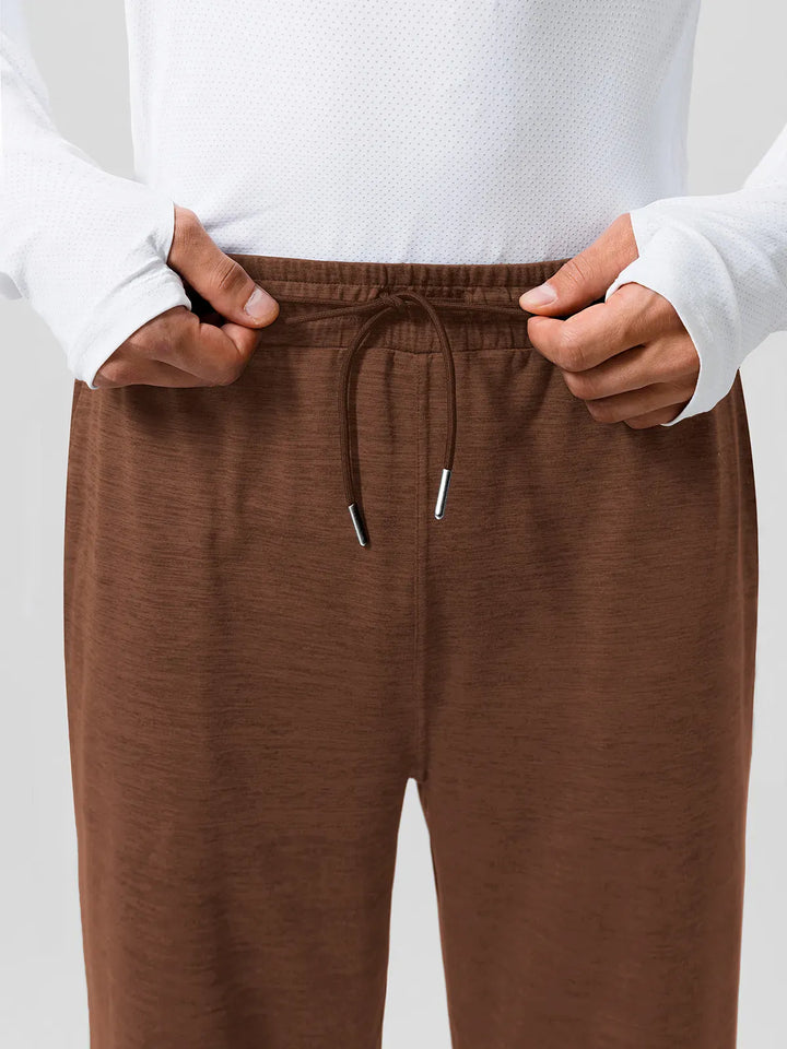 A model wearing a BRXL® Men’s Smooth Four Pockets Tapered Joggers in