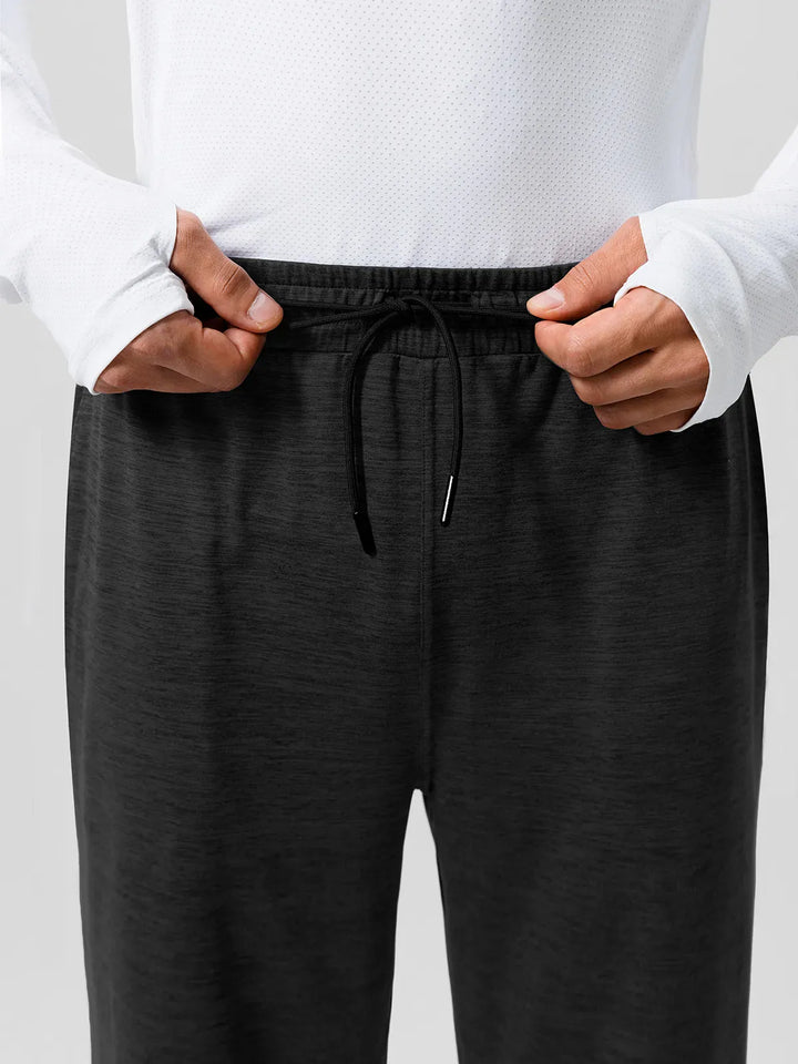 A model wearing a BRXL® Men’s Smooth Four Pockets Tapered Joggers in