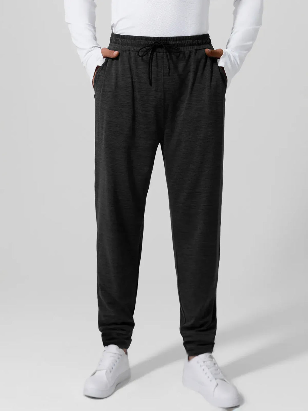 A model wearing a BRXL® Men’s Smooth Four Pockets Tapered Joggers in Black / S