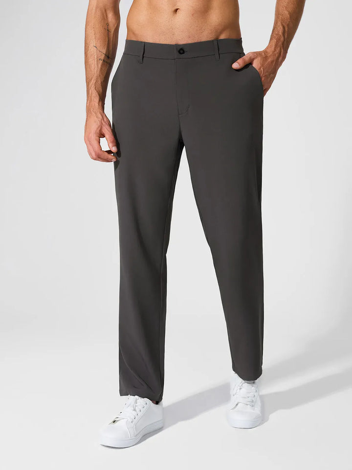 A model wearing a BRXL® Men’s Straight Leg Golf Pants in Dark Gray / S