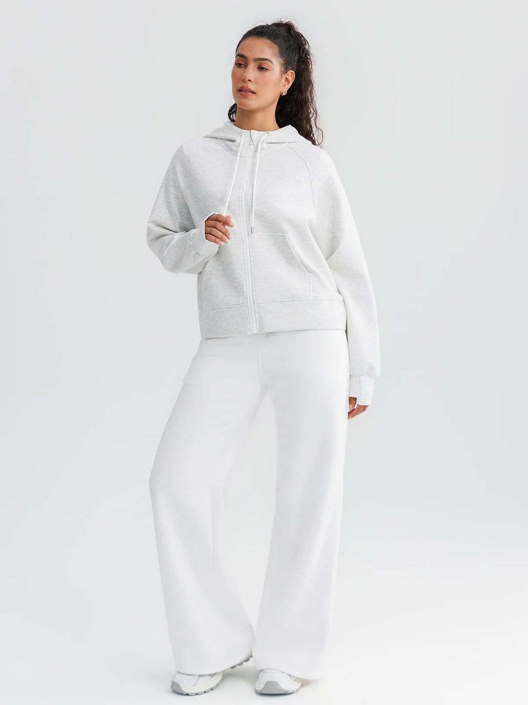 A model wearing a BRXL® Oversized Cropped Zip-Up Comfort Hoodie