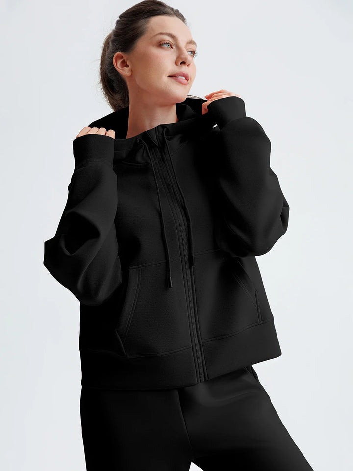 A model wearing a BRXL® Oversized Cropped Zip-Up Comfort Hoodie Black / XS